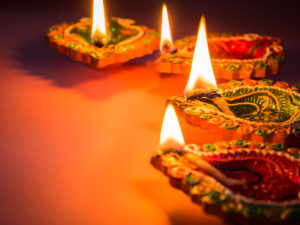 Colorful and sparkling clay diya lamps lit for the Hindu Diwali festival.